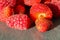 Domestic strawberry and rapsbery on marble texture, macro photo