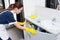 Domestic worker opening sink cabinet