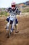 Dominating the track. A young motocross rider speeding towards the camera.