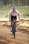 Dominating the trails. A young man riding his mountain bike on a forest trail.