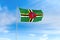 Dominica flag over blue sky background