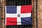 Dominican flag on the facade of the building, Santo Domingo, Dominican Republic. Close-up.