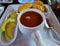 Dominican mondongo stew with fried plantains and avocado