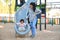 Dominican mother playing with her toddler daughter at the slide in a park.