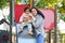 Dominican mother playing with her toddler daughter at the slide in a park.