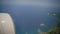 Dominican Republic aerial view from the plane window. Under the wing of the aircraft visible coast of caribbean sea