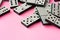 Domino tiles on pink background studio shot