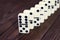 Dominoes game on a wooden table, brown background. Board game domino. Gambling
