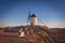 Don Quixote windmills at sunset. Famous landmark in Consuegra, Toledo Spain.