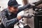 Don`t delay with repair. Close-up of repairman examining oven