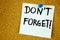 don& x27;t forget written on color sticker notes over cork board background