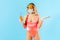 Don`t know how drink safe! Confused uncertain woman in swimsuit, hygienic face mask and gloves, having troubles