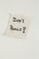 A Don\\\'t panic note on a piece of paper on a white surface - panic because of Covid-19