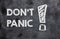 DON`T PANIC text on a black chalk board