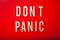 Don`t panic word text wooden letter on red background coronavirus covid-19