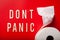 Don`t panic word toilet paper text wooden letter on red background coronavirus covid-19