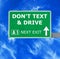 DON\'T TEXT & DRIVE road sign against clear blue sky