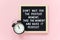 Don`t wait for the perfect moment, take the moment and make it perfect. Motivational quote on letter board, black alarm clock on