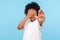 Don`t want to watch! Portrait of scared little boy with curls covering eyes with hand and showing stop gesture