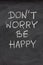 Don\'t worry be happy phrase on blackboard