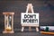 Don`t Worry. Sandglass, hourglass or egg timer on wooden table