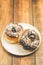 Donat in chocolate in a white bowl on a wooden background. Top view