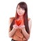 Donate heart. Girl holding red heart. Isolated on white.