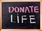 Donate life word on blackboard