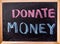Donate money word on blackboard