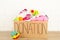 Donation box with baby clothes on light background