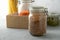 Donation box on the table. Food Delivery Concept. Jars with various cereals in a cardboard box.