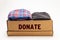 Donation concept. Donation box with donation clothes on a white background. Charity. Helping needy people