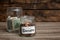 Donation jars with money on table