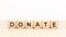 Donation word on wooden block shape