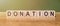 DONATION word written on wooden blocks on wooden table. Concept for your design