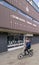 Doncaster central library exterior building with blurry caucasian man cycling.