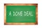 A  DONE  DEAL text written on green school board