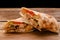 Doner Kebab Gyros Shawarma beef roll in pitta bread Wrap sandwich on wooden background