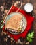 Doner kebab with meat cutlets and vegetables on a plate with a red napkin and garlic sauce On wooden rustic background, top view