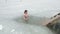 DONETSK, UKRAINE-JANUARY 19: Woman swimming in a ice-hole. Orthodox tradition