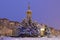 Donetsk, Ukraine. January 7, 2020.Church of St. Blessed Xenia of Petersburg.Snowy winter, predawn time.Parishioners standing on