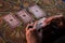 DONETSK, UKRAINE - JUNE 10, 2021: Close up female hands holding tarot cards. Fortuneteller. Witchcraft.