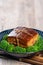 Dong Po Rou Dongpo pork meat in a plate with green vegetable, traditional festive food for Chinese lunar new year cuisine meal,
