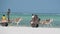 Donkey Carts with Local Africans Ride along the Sandy Beach by Ocean, Zanzibar
