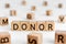 Donor - word from wooden blocks with letters