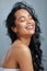 Dont allow anyone to dim your glow. Studio shot of an attractive young woman posing with wet hair against a grey