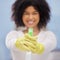 Dont bring your germs near me. a young woman standing alone and spraying a bottle of detergent while doing the chores at