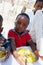 Dont even think about it...Cropped portrait of a young boy getting fed at a food outreach.