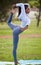 Dont get bent out of shape. Get bent into it. a young woman practicing her yoga in the park.