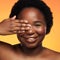 Dont hide your beauty from the world. Studio shot of a beautiful young woman posing against an orange background.